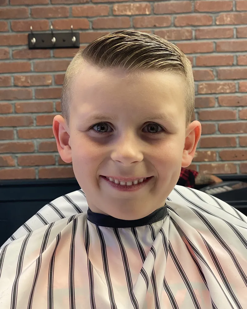 Boy smiling after a classic haircut