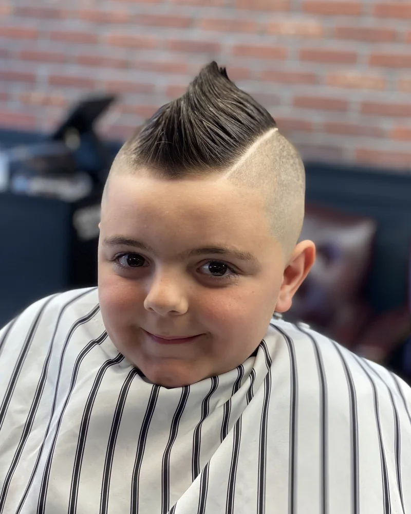 Boy with a faux hawk and hard part